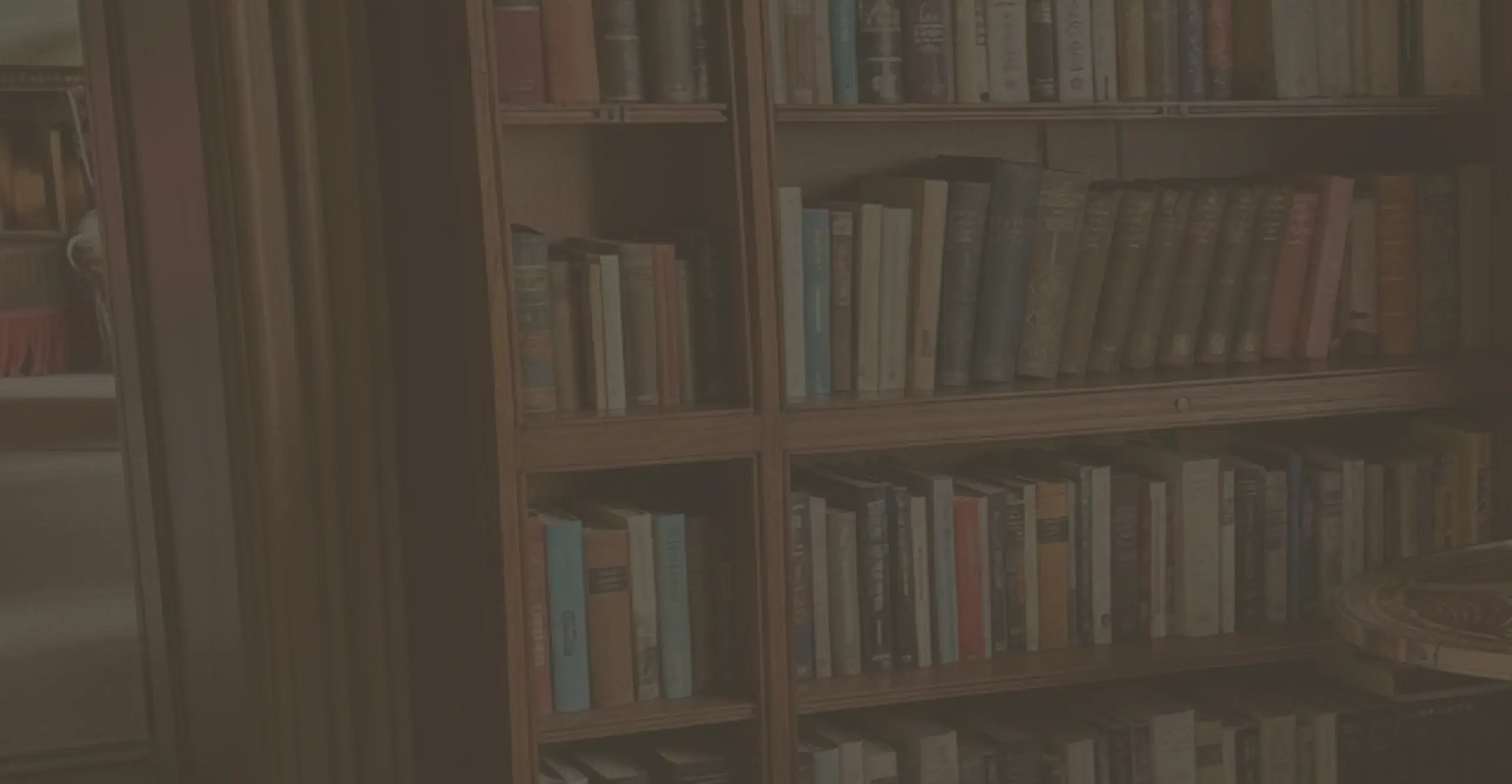 Shelves of books in a warmly lit study