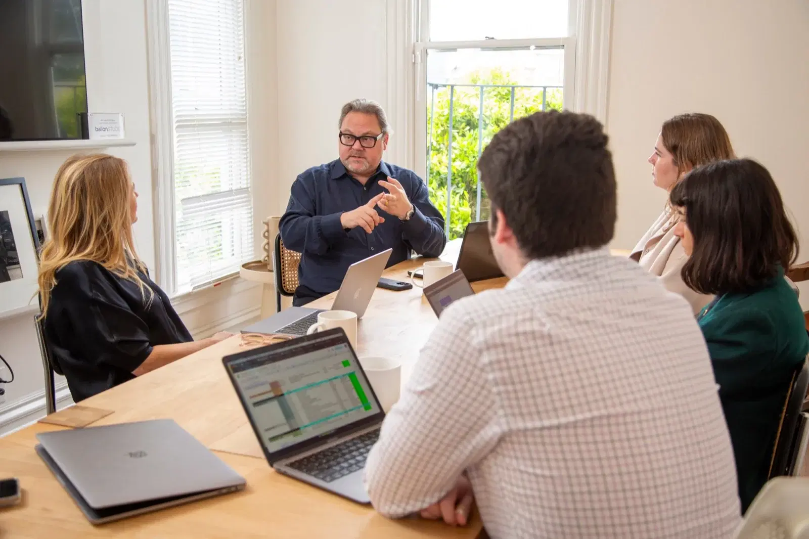 Julian Lighton coaching a client across a table